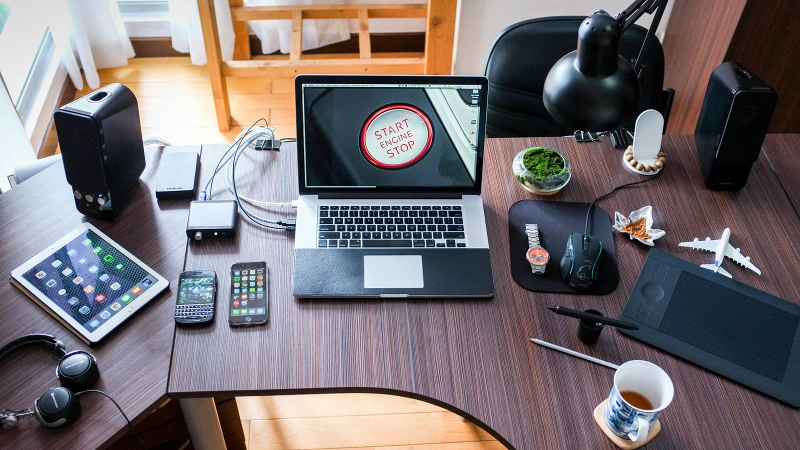 Home desk with phones, tablet, laptop, and connected accessories