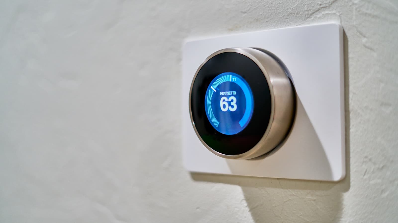 Smart thermostat on a residential wall