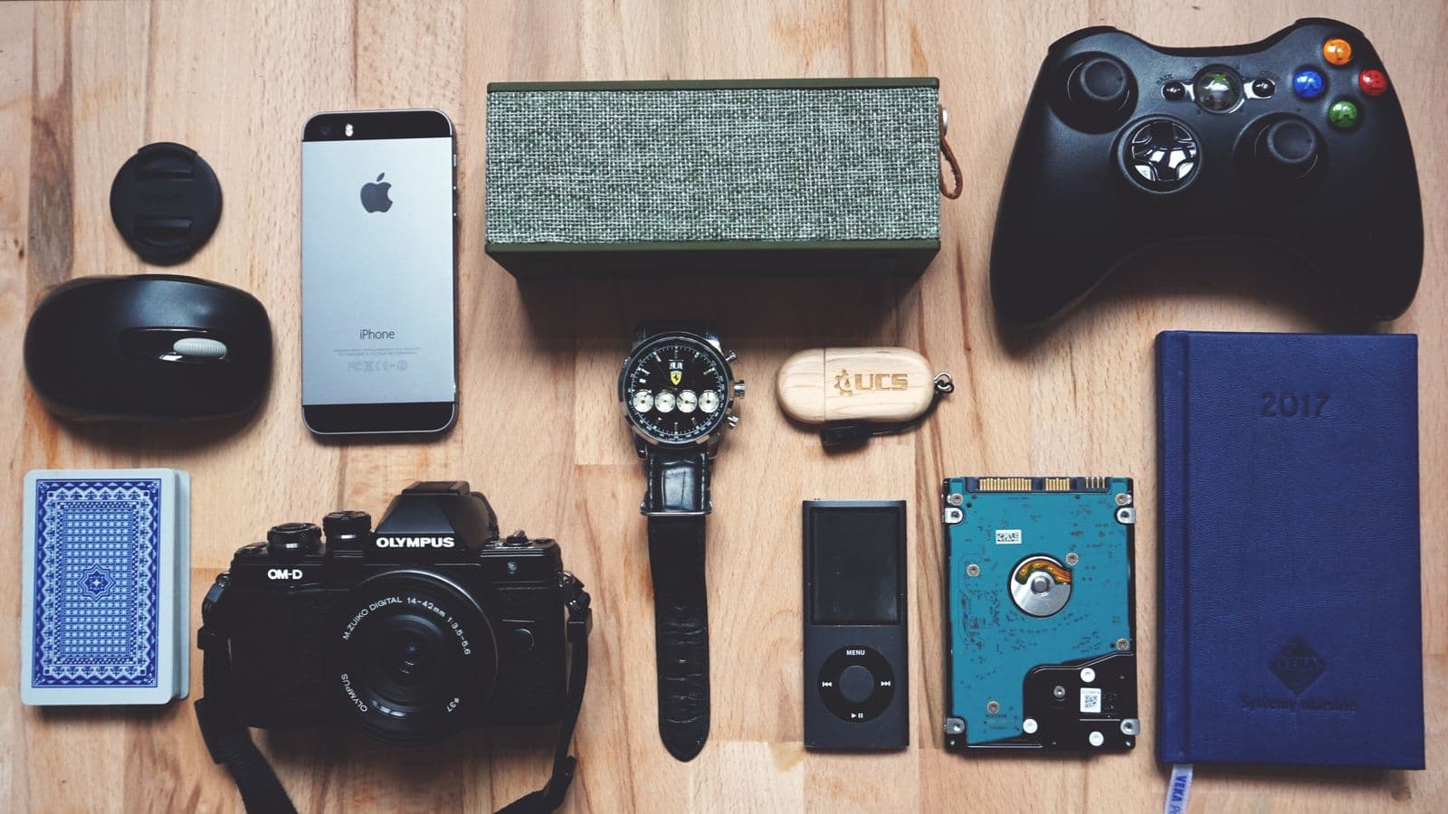Flat lay of older personal electronics on a wooden table
